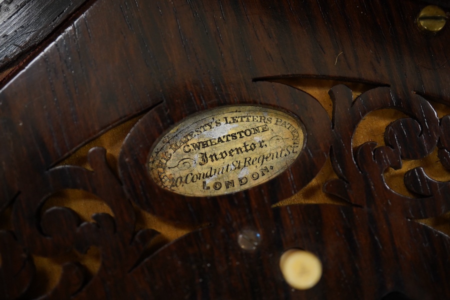 A Wheatstone concertina in a rosewood case, concertina closed 15.5cm wide. Condition - box handle missing, concertina good